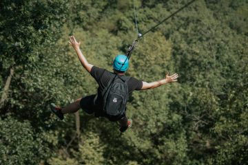 Jumping of on A zipline over beautiful Green trees.