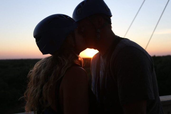 a man standing in front of a sunset