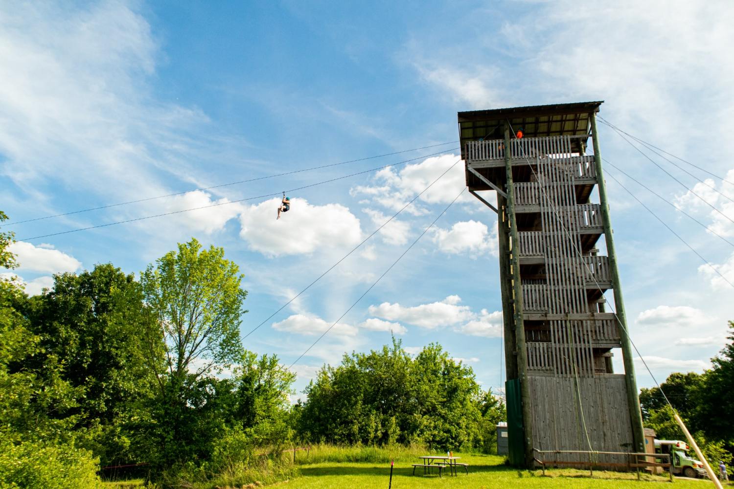 a large tall tower with a clock at the top of a field